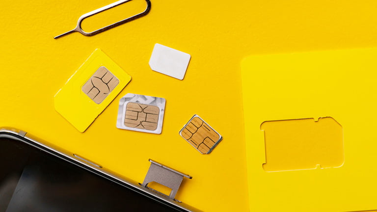 Change a SIM card in an iPhone with ejecting tool and various types of SIM cards